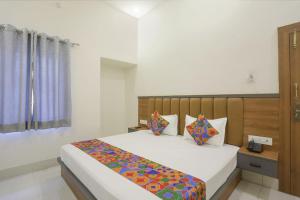 Postel nebo postele na pokoji v ubytování Via Downtown Residency