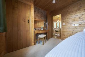 a bedroom with a bed and a desk at Gadwall Lodge with Hot-tub in Carlisle