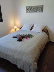 ein Schlafzimmer mit einem großen Bett mit Blumen darauf in der Unterkunft Les Balisiers du Sud in Saint-Joseph