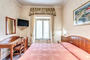 a bedroom with a bed and a desk and a computer at Hotel Milo in Rome