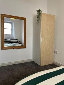 a room with a mirror on the wall and a door at Little Dockray One-Bed Apartment Centre of Penrith in Penrith +4 photos