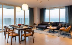 a living room with a couch and a table at Alma Resort Cam Ranh in Cam Ranh