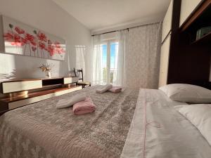 a bedroom with a large bed with two pillows on it at Apartment Ciba in Komiža