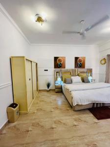 een grote slaapkamer met 2 bedden en een plafond bij The Highrise Hideaway in Dar es Salaam