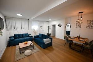 a living room with a blue couch and a table at APARTMAN SOKOL II **** in Velika Gorica