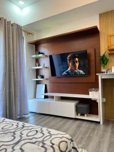 a living room with a flat screen tv on a wall at Amani Grand Citygate at the back of Gaisano Milan in Davao City