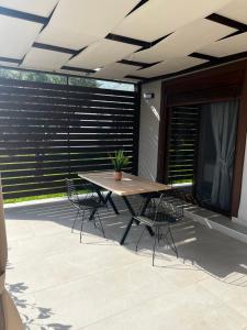 a wooden table and chairs on a patio at Naiades Villas Lilea in Ladharió