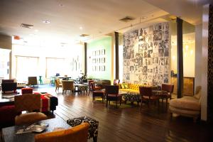 a living room with chairs and tables and a lobby at Loft 523 in New Orleans