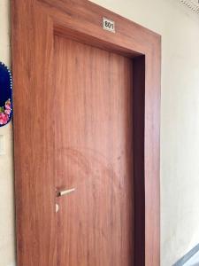 a wooden door with a sign that reads exit at Mansha niwas - kahana home in Vrindāvan