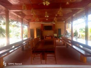 a dining room with a long table and chairs at Serene Resort Phú Quốc in Phu Quoc