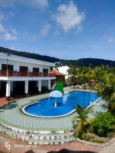 a resort with a large swimming pool in front of a building at Serene Resort Phú Quốc in Phu Quoc