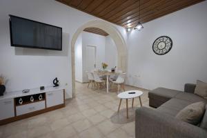 a living room with a couch and a table at Dianna Residence in Rethymno Town