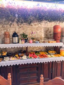 uma linha de buffet com muitos tipos diferentes de alimentos em Pousada Rosa de Saron em Holambra