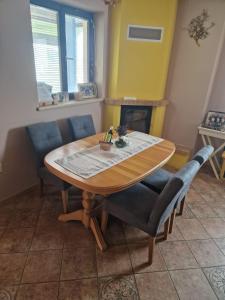 a table and chairs in a room with a fireplace at Garden View in Drienica