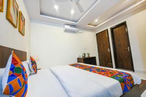 1 dormitorio con cama y ventana en FabHotel Jaswinder Bhawan en Haridwār