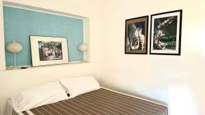 En eller flere senge i et værelse på Palme 1C - Marcelli, monolocale con giardino, Residence Le Palme