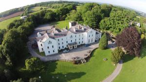 an aerial view of a large house on a green field at Court Colman Manor in Bridgend