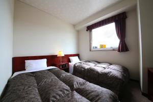 Un pat sau paturi într-o cameră la ホテルパブリック21