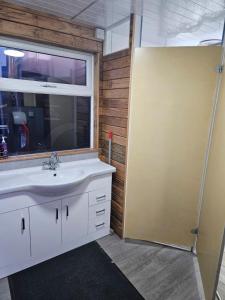 a bathroom with a sink and a window at Trailor Escape GLAMPING POD - our converted horse box at Nelson Park Riding Centre - Birchington, Margte, Thanet, Ramsgate, Broadstairs, Sandwich, Herne Bay in Birchington +27 photos