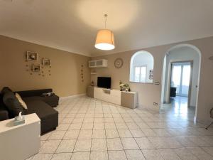 a living room with a couch and a tv at La Casa di Ania in Savona