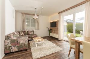 a living room with a couch and a table at Appartmenthaus Martina by Schladming-Appartements in Haus im Ennstal +3 photos