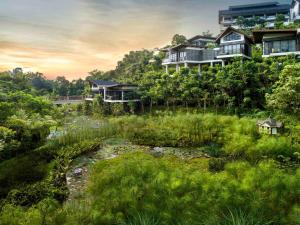 a house on top of a hill with a creek at Pullman Ciawi Vimala Hills Resort in Bogor