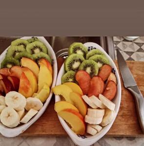 two bowls filled with different types of fruit on a cutting board at Corte Moline in Gallipoli
