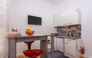 a kitchen with a table with a bowl of fruit on it at Studio rooms Bakar in Bakar