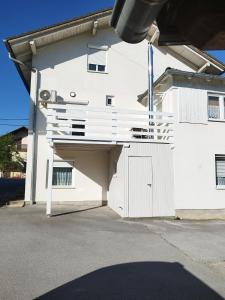a white house with a garage with a white door at Apartments Matijevic in Grabovac