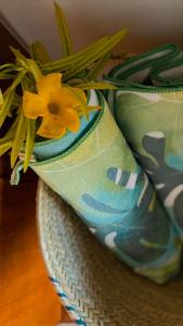 a yellow flower on top of a pair of shoes at Zanzibar Gem Beach Bungalows in Bwejuu
