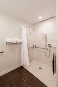 a bathroom with a shower with a shower curtain at Jamaica Bay Inn Marina Del Rey Tapestry Collection by Hilton in Los Angeles
