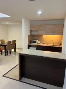 a kitchen and dining room with a table and chairs at Studio Exclusive (Kota Bharu City Point) in Kota Bharu