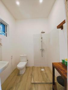 a bathroom with a toilet and a shower at Zanzibar Gem Beach Bungalows in Bwejuu