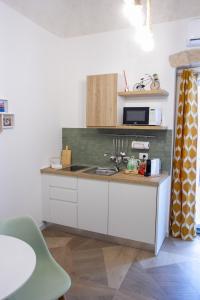 a kitchen with a counter with a sink and a microwave at Bari in un click in Bari