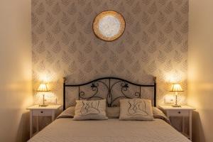 a bedroom with a large bed with two nightstands and two lamps at Playa Arrigunaga Getxo con parking in Getxo