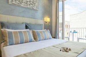 Postel nebo postele na pokoji v ubytování Hotel Soffio D'Estate