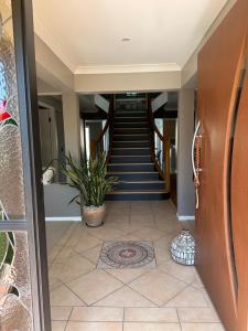 a hallway of a house with a staircase with a plant at Relaxing Burleigh Heads Home with Swimming Pool in Gold Coast