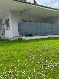 a building with a fence in a field of grass at Pension - Panorama in Gundelsheim