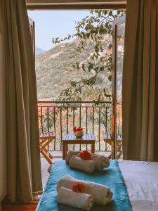 a room with two beds with a view of a mountain at Club Hotel Barbarossa in Kaş