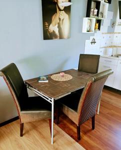 a dining room table with two chairs and a table at Jasień 77 A in Czarna Dąbrówka