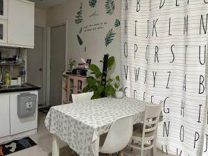 a kitchen with a table with a white table cloth at Veganhome in Ho Chi Minh City