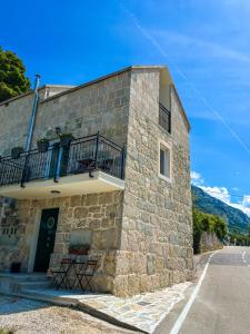 a stone building with a balcony on the side of it at Old stone house Klarić in Brela