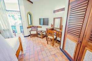 a room with a desk and a table with a mirror at Severin Sea Lodge in Mombasa