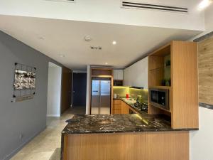a kitchen with a counter top in a room at Anggun Suite KL in Kuala Lumpur
