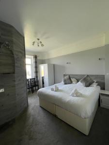 a bedroom with a large white bed in a room at Lundy House Hotel in Woolacombe