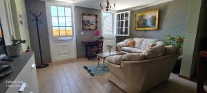 a living room with a couch and a table at Casa do Amigo in Seixal