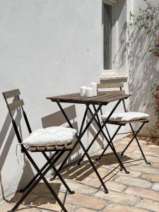 a wooden table and two chairs on a patio at Casale delle Lavande in Citta' Sant'Angelo