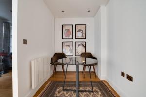 a dining room with two chairs and a table at Lovely Charing Cross Apartment in London
