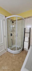 a bathroom with a shower with a glass door at Casa do Amigo in Seixal