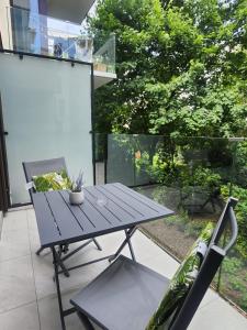 a picnic table and a chair on a patio at A charming loft in the heart of KRAKÓW with free parking in Krakow